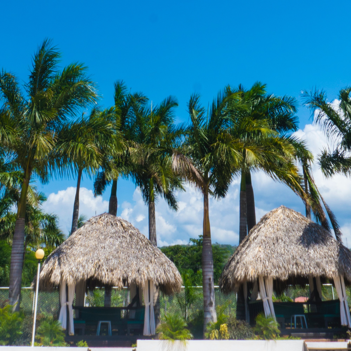 bottom layer with thatch huts and palm trees